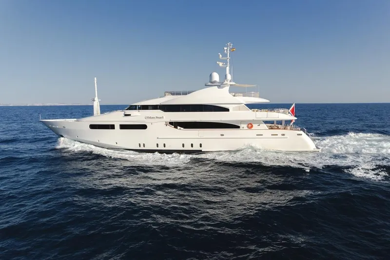 Titian Pearl Yacht Photos Pics Luxurious 2001 CRN Magnifica yacht cruising on open sea under clear blue sky.