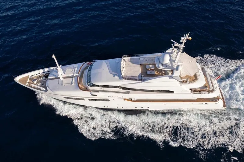 Titian Pearl Yacht Photos Pics Luxurious 2001 CRN Magnifica yacht cruising on open sea, aerial view.