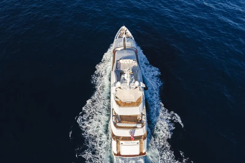 Titian Pearl Yacht Photos Pics Aerial view of 2001 CRN Magnifica yacht cruising on open sea.