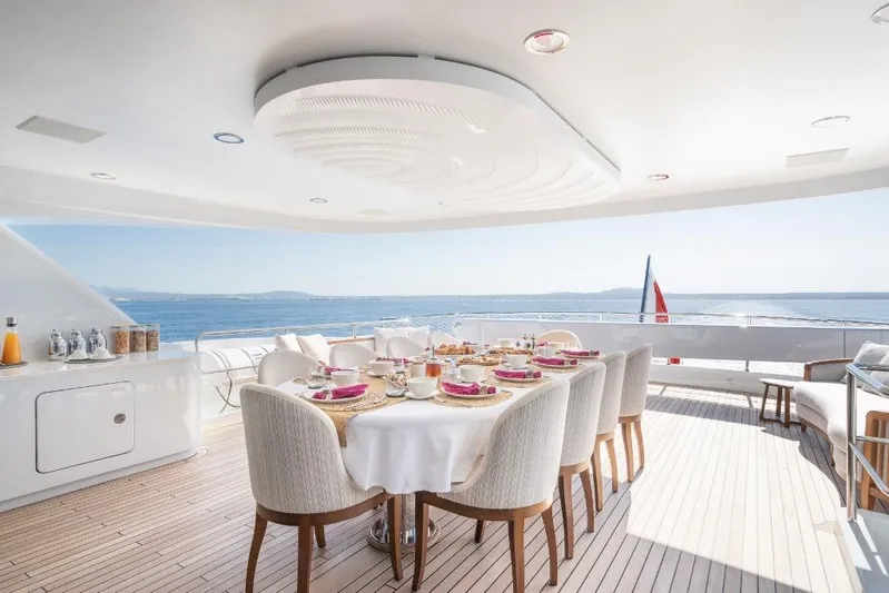 Titian Pearl Yacht Photos Pics Luxurious dining area on CRN Magnifica yacht, 2001 model, with ocean view and elegant table setting.