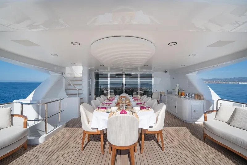 Titian Pearl Yacht Photos Pics Luxurious dining area on CRN Magnifica yacht, 2001 model, with ocean view and elegant table setting.