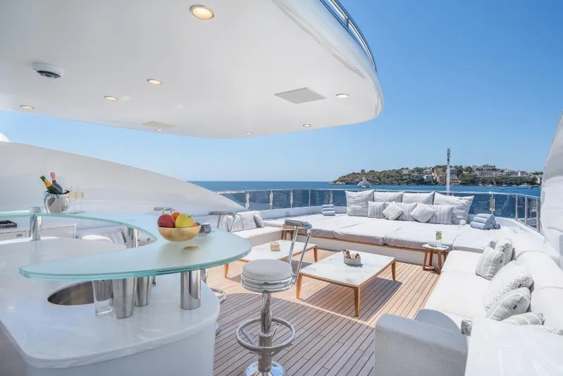 Titian Pearl Yacht Photos Pics Luxurious CRN Magnifica 2001 yacht deck with elegant seating, bar, and ocean view.