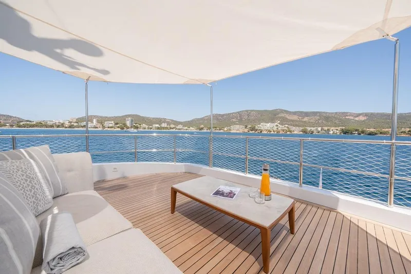 Titian Pearl Yacht Photos Pics Luxury yacht deck with ocean view, featuring a cozy seating area and refreshments. CRN Magnifica 2001.