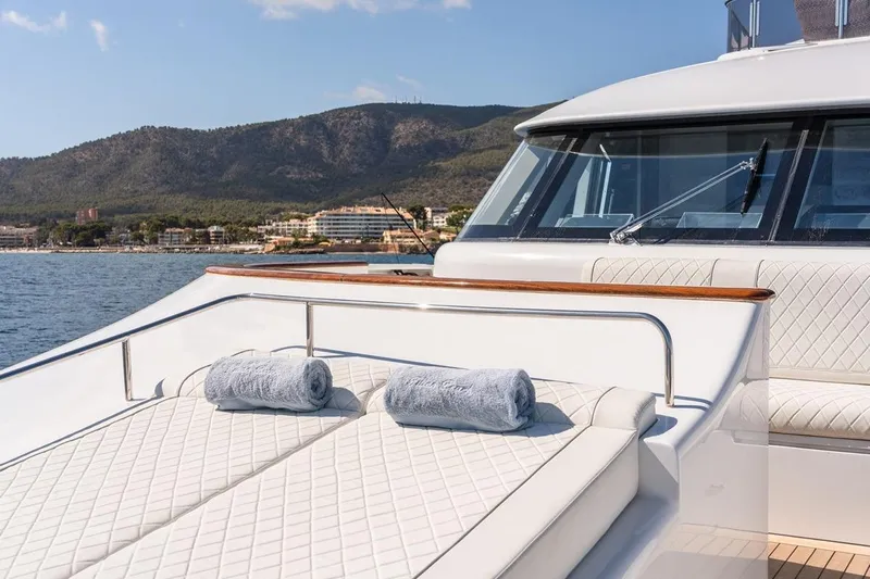 Titian Pearl Yacht Photos Pics Luxury yacht CRN Magnifica 2001 with sunbathing deck and scenic coastal view.