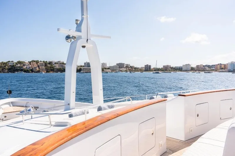 Titian Pearl Yacht Photos Pics Luxury yacht CRN Magnifica 2001 on serene blue waters with cityscape in background.