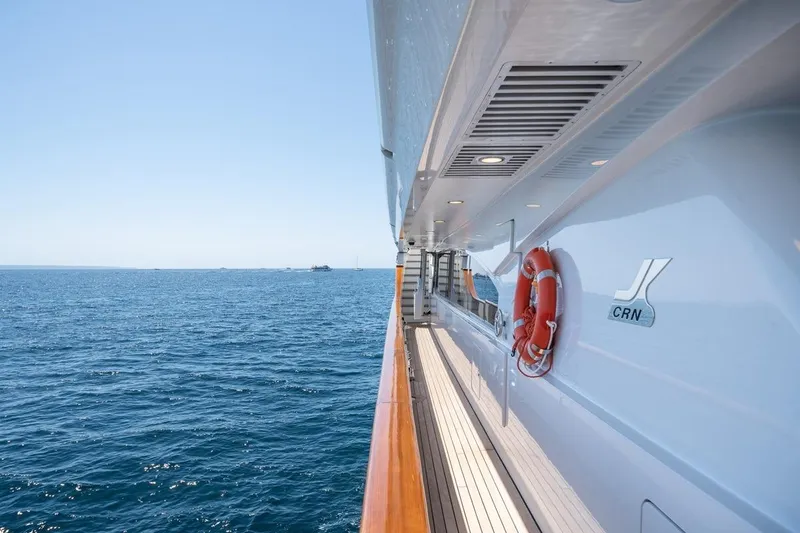 Titian Pearl Yacht Photos Pics CRN Magnifica yacht deck view, 2001 model, overlooking the ocean with clear blue skies.