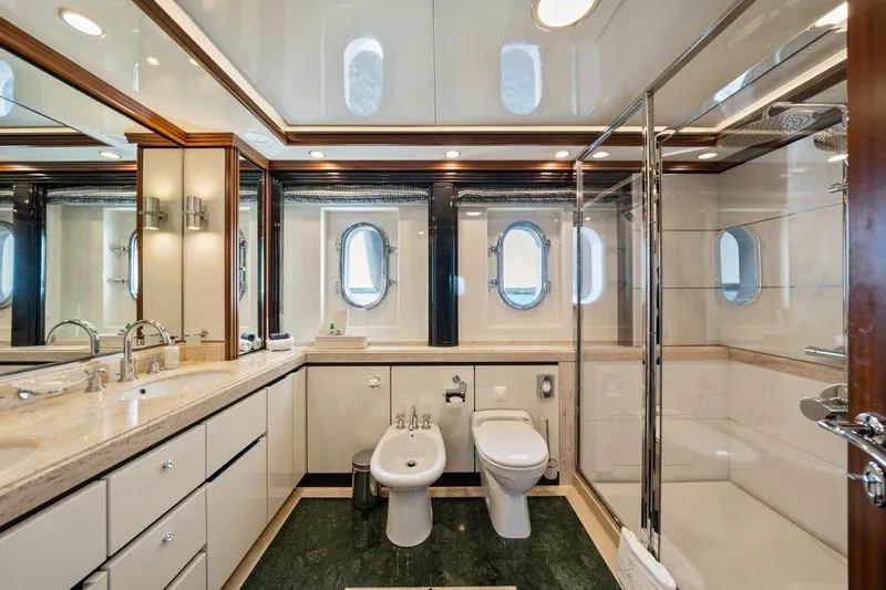 Titian Pearl Yacht Photos Pics Luxurious yacht bathroom with dual sinks, glass shower, and porthole windows on CRN Magnifica 2001.