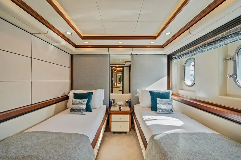 Titian Pearl Yacht Photos Pics Luxurious twin cabin interior on 2001 CRN Magnifica yacht with elegant decor and porthole windows.