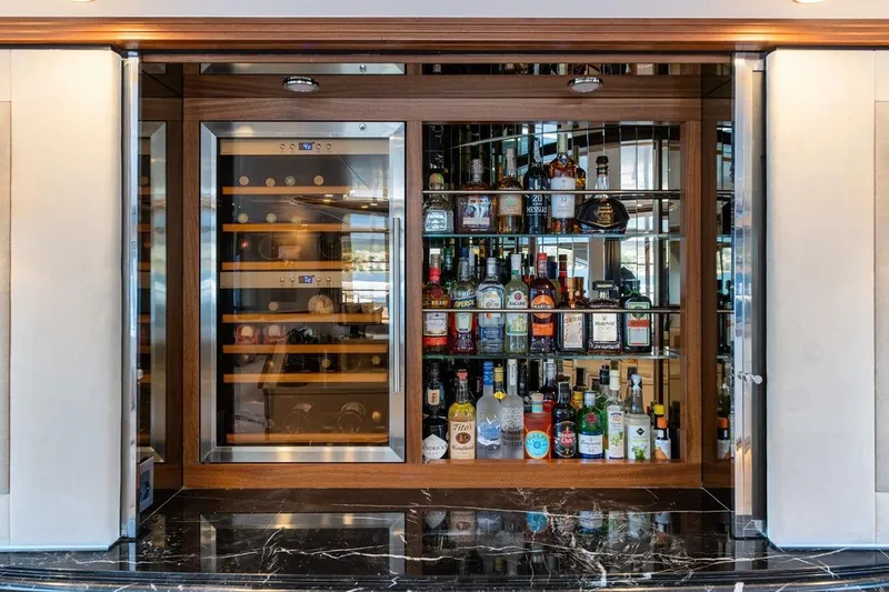 Titian Pearl Yacht Photos Pics Luxurious yacht bar with wine cooler and assorted liquor bottles, CRN Magnifica 2001.