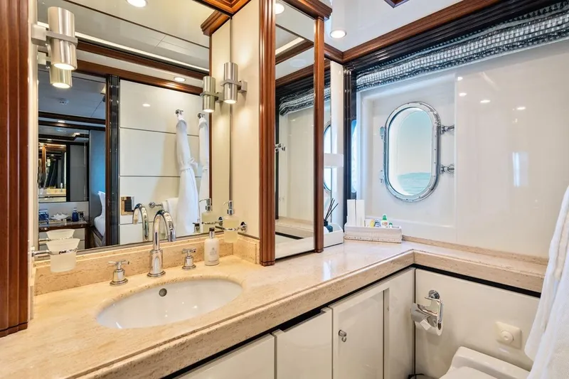 Titian Pearl Yacht Photos Pics Luxurious yacht bathroom with elegant fixtures, porthole window, and marble countertop on CRN Magnifica 2001.