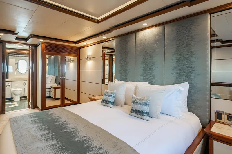 Titian Pearl Yacht Photos Pics Luxurious bedroom on 2001 CRN Magnifica yacht with elegant decor and ensuite bathroom.
