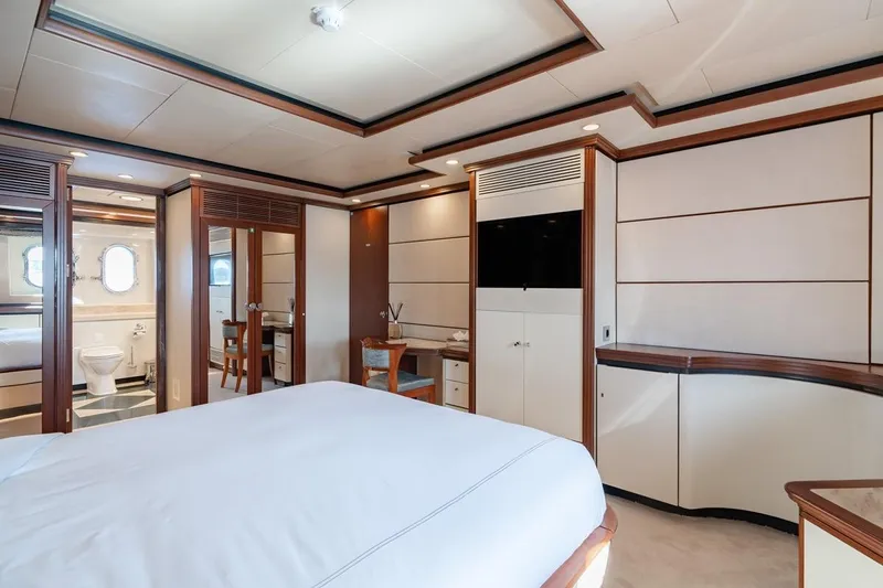 Titian Pearl Yacht Photos Pics Luxurious CRN Magnifica 2001 yacht bedroom with elegant wood accents and ensuite bathroom.