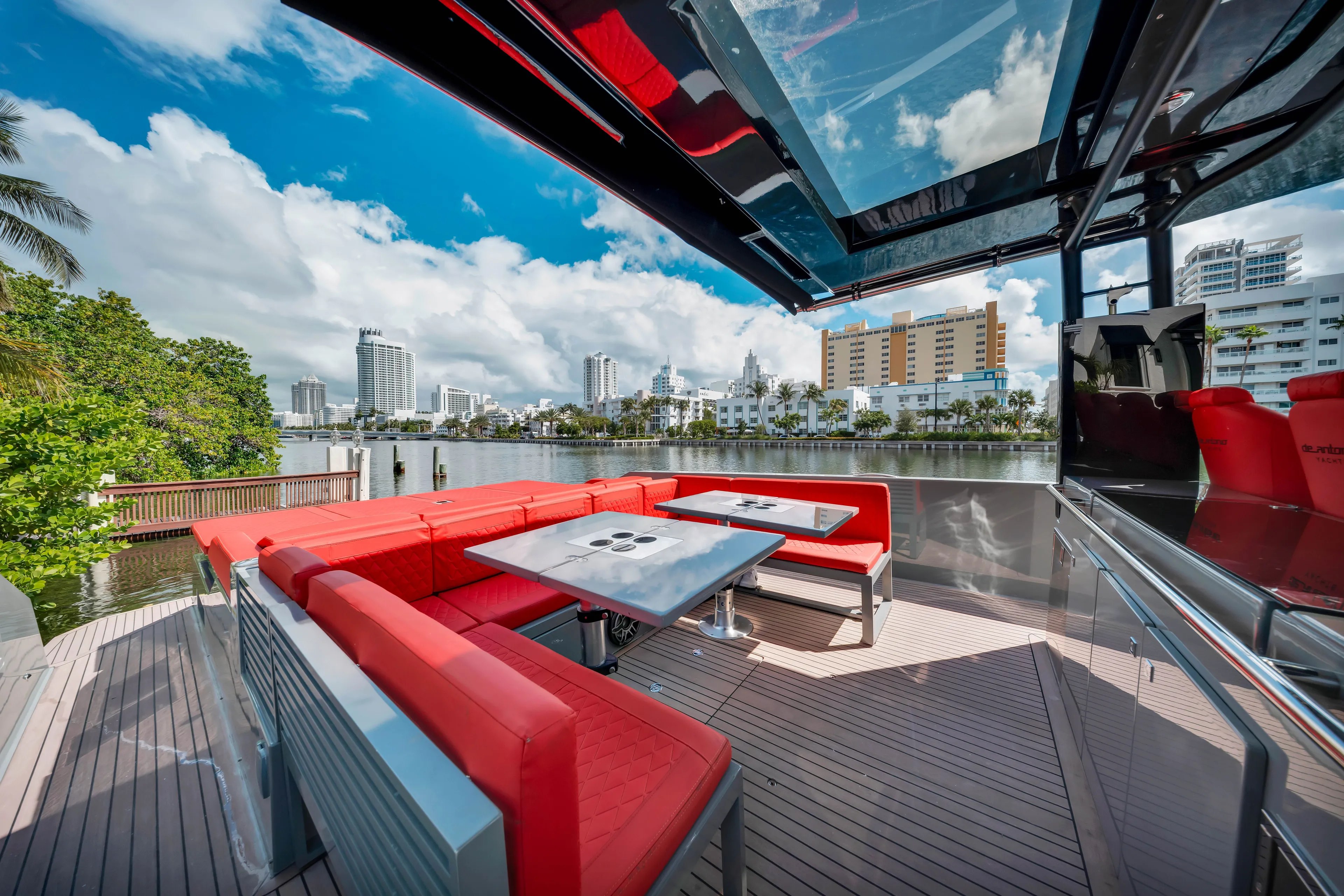 Painkiller Yacht Photos Pics Luxurious 2023 De Antonio Yachts D42 Open with red seating, cityscape view, and sleek design.
