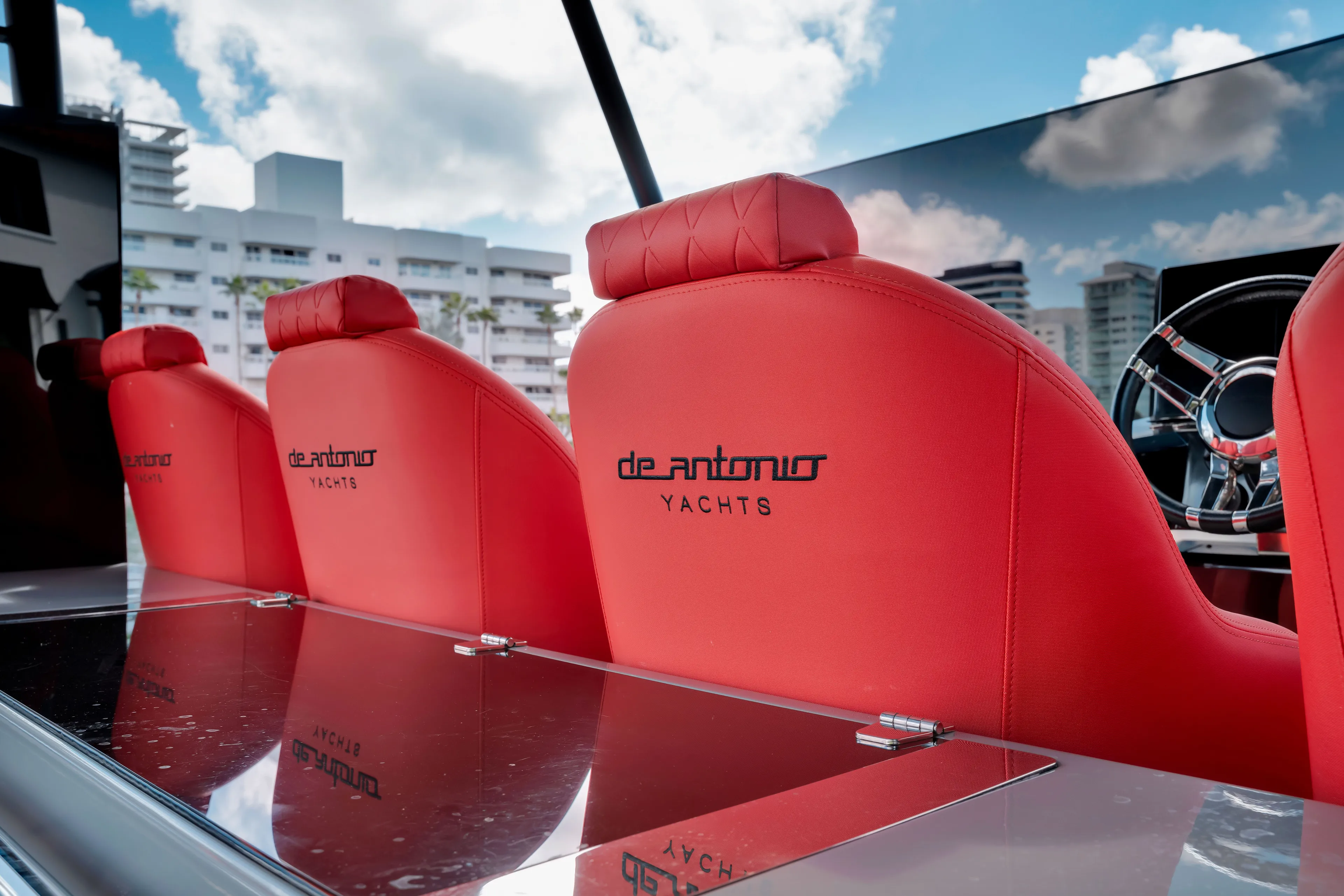 Painkiller Yacht Photos Pics Red leather seats on 2023 De Antonio Yachts D42 Open, with cityscape background.