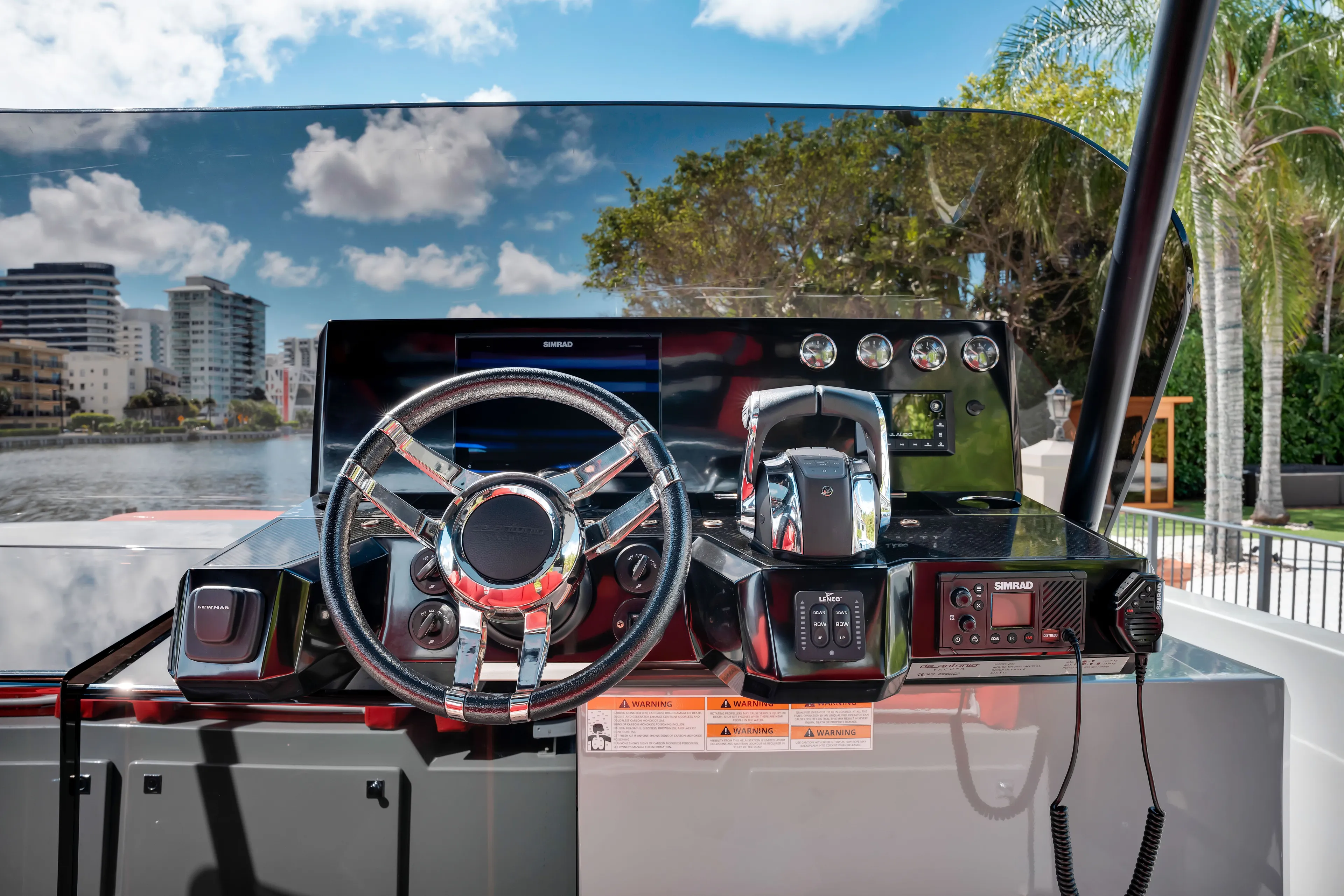 Painkiller Yacht Photos Pics 2023 De Antonio Yachts D42 Open helm with modern controls and cityscape reflection.