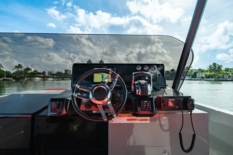 Painkiller Yacht Photos Pics 2023 De Antonio Yachts D42 Open helm with modern controls and scenic waterway view.