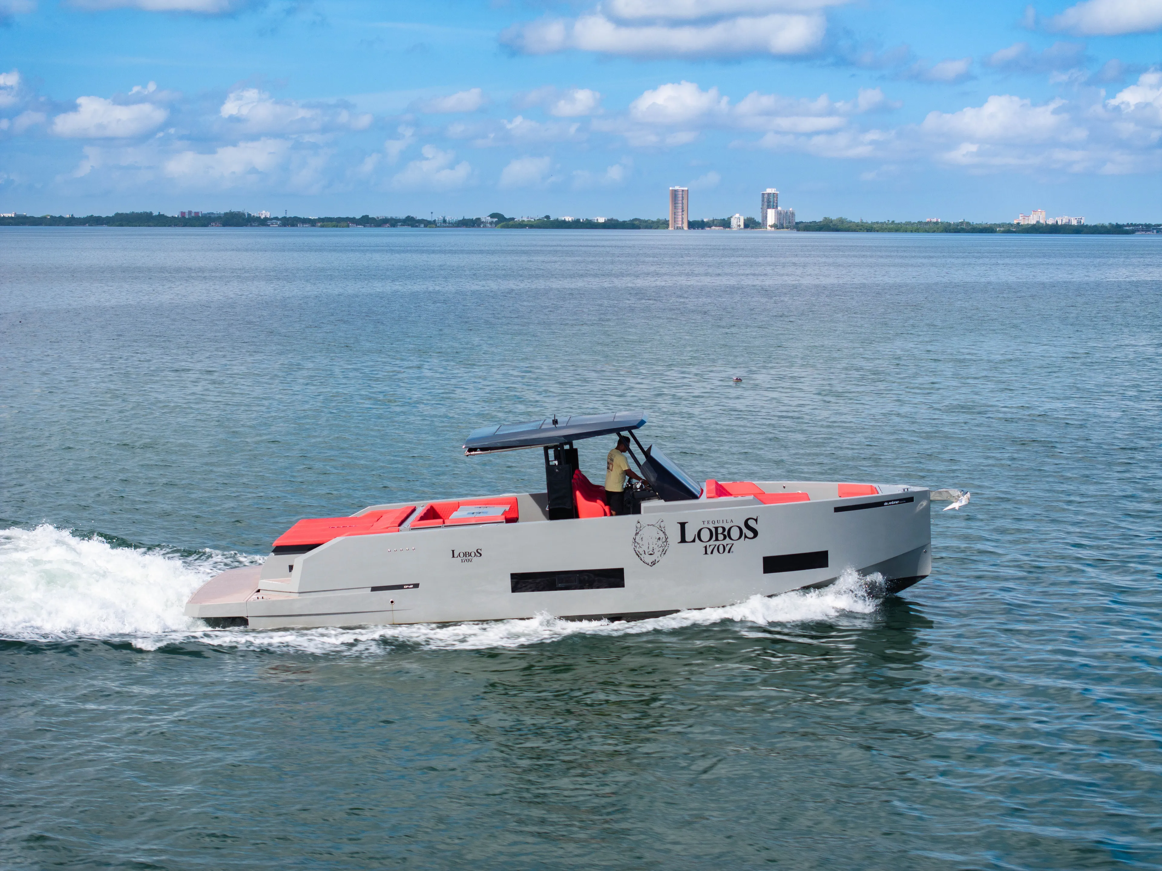 Painkiller Yacht Photos Pics 2023 De Antonio Yachts D42 Open cruising on a sunny day, featuring sleek design and vibrant accents.