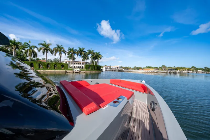 Painkiller Yacht Photos Pics 2023 De Antonio Yachts D42 Open on serene water with palm trees and luxury homes.