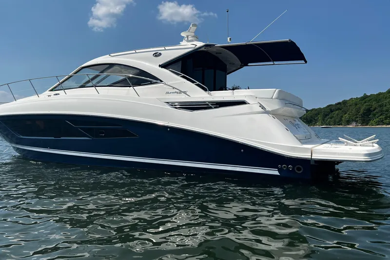 Party Of 5 Yacht Photos Pics 2014 Sea Ray 510 Sundancer yacht on calm water under blue sky.