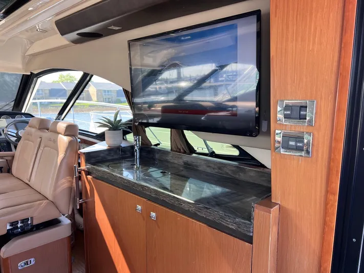 Party Of 5 Yacht Photos Pics Luxurious interior of 2014 Sea Ray 510 Sundancer yacht with TV and seating area.