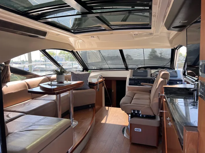 Party Of 5 Yacht Photos Pics Luxurious interior of 2014 Sea Ray 510 Sundancer yacht with plush seating and modern helm.