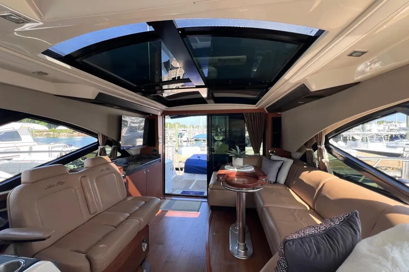 Party Of 5 Yacht Photos Pics Luxurious interior of 2014 Sea Ray 510 Sundancer yacht with leather seating and panoramic windows.