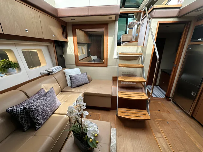Party Of 5 Yacht Photos Pics Luxurious interior of 2014 Sea Ray 510 Sundancer yacht with modern seating and wooden staircase.