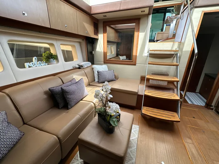 Party Of 5 Yacht Photos Pics Luxurious interior of 2014 Sea Ray 510 Sundancer yacht with elegant seating and wooden stairs.