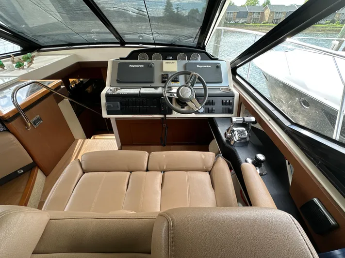 Party Of 5 Yacht Photos Pics 2014 Sea Ray 510 Sundancer helm with leather seating and advanced navigation controls.