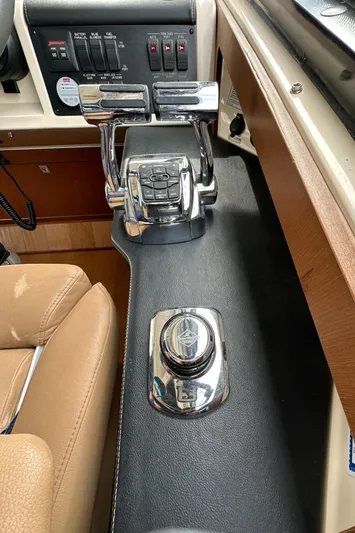 Party Of 5 Yacht Photos Pics Control panel of a 2014 Sea Ray 510 Sundancer yacht, featuring throttle and joystick.