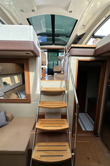 Party Of 5 Yacht Photos Pics Interior view of 2014 Sea Ray 510 Sundancer yacht with wooden stairs and modern design.
