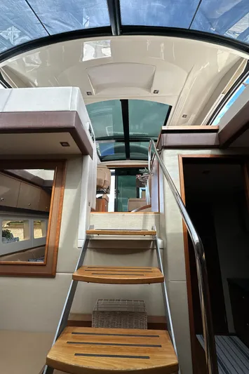 Party Of 5 Yacht Photos Pics Interior view of 2014 Sea Ray 510 Sundancer yacht with wooden stairs and glass ceiling.