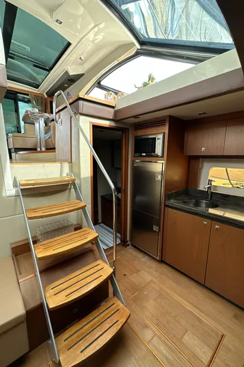 Party Of 5 Yacht Photos Pics Interior of 2014 Sea Ray 510 Sundancer yacht with wooden stairs and modern kitchen.