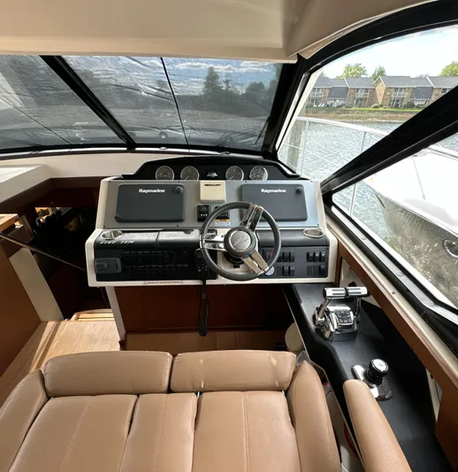 Party Of 5 Yacht Photos Pics 2014 Sea Ray 510 Sundancer helm with modern controls and waterfront view.