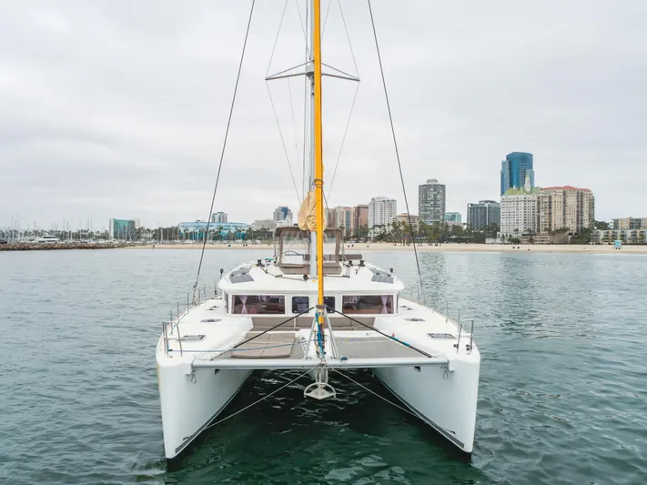 Limoncello Yacht Photos Pics 2016 Lagoon 450F catamaran on water with city skyline in background.