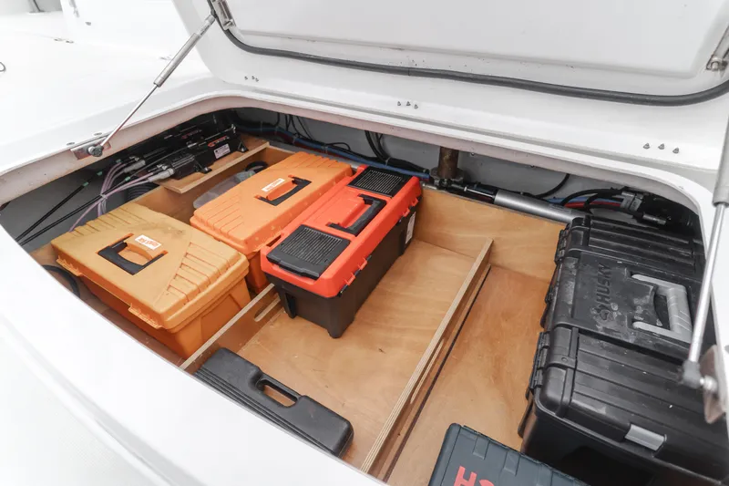 Limoncello Yacht Photos Pics Storage compartment of 2016 Lagoon 450F with organized toolboxes and equipment.