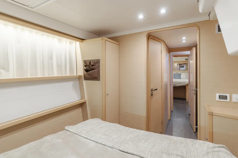 Limoncello Yacht Photos Pics Interior of 2016 Lagoon 450F yacht, featuring a cozy bedroom with modern design.