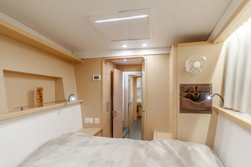 Limoncello Yacht Photos Pics Interior of 2016 Lagoon 450F yacht cabin, featuring modern design and cozy sleeping area.