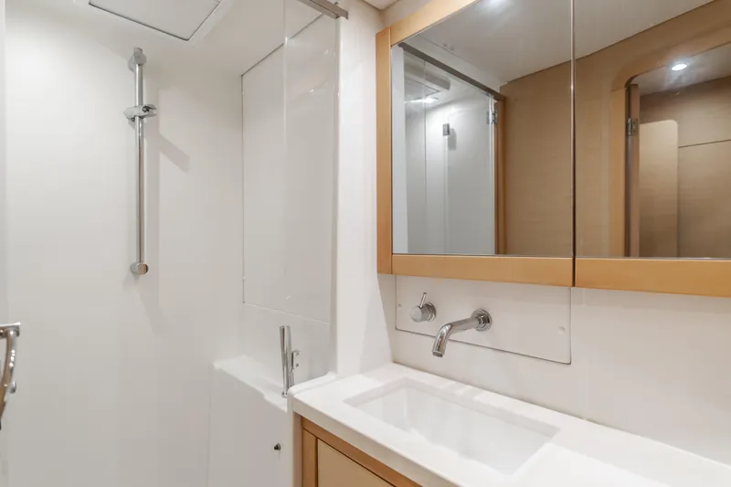 Limoncello Yacht Photos Pics Modern bathroom in 2016 Lagoon 450F yacht with sleek fixtures and mirror.