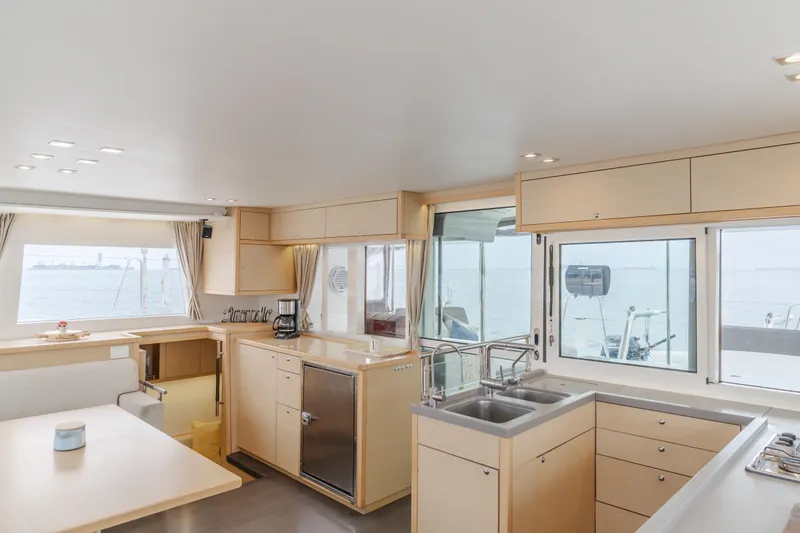 Limoncello Yacht Photos Pics Spacious interior of 2016 Lagoon 450F catamaran with modern kitchen and large windows.