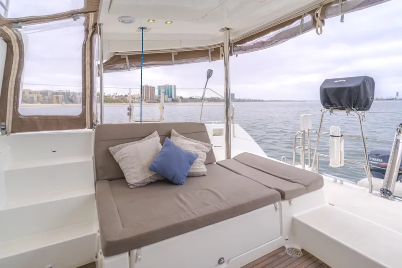 Limoncello Yacht Photos Pics Lagoon 450F 2016 yacht deck with cushioned seating and scenic water view.