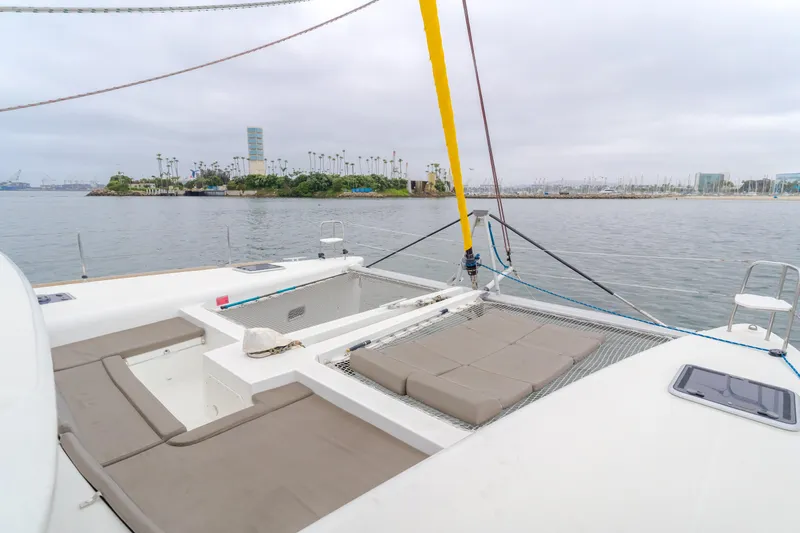 Limoncello Yacht Photos Pics 2016 Lagoon 450F catamaran with spacious deck and seating, docked near a scenic waterfront.