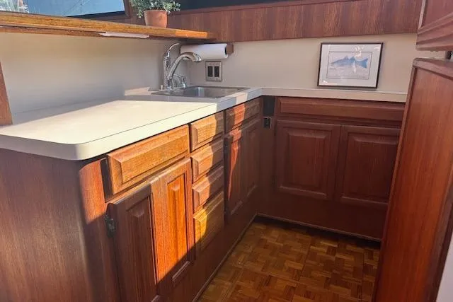 Arete Yacht Photos Pics 1988 Viking 45 Convertible yacht kitchen with wooden cabinets and countertop.