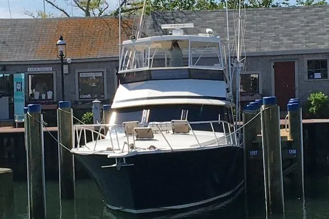 Arete Yacht Photos Pics 1988 Viking 45 Convertible yacht docked at a marina, front view.