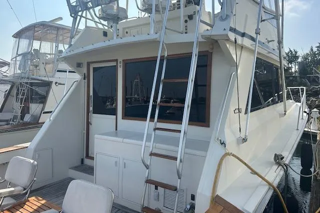 Arete Yacht Photos Pics 1988 Viking 45 Convertible yacht docked, featuring spacious deck and ladder access.