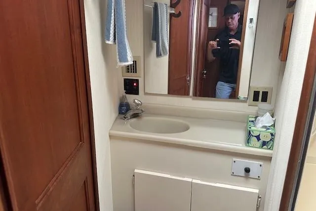 Arete Yacht Photos Pics Bathroom interior of a 1988 Viking 45 Convertible yacht with sink and mirror.