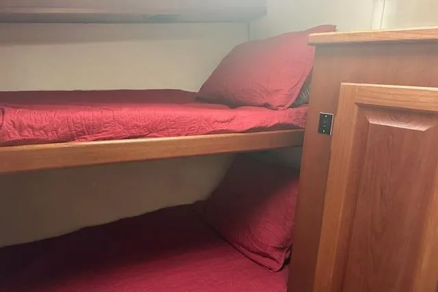 Arete Yacht Photos Pics Bunk beds with red bedding in a 1988 Viking 45 Convertible yacht cabin.