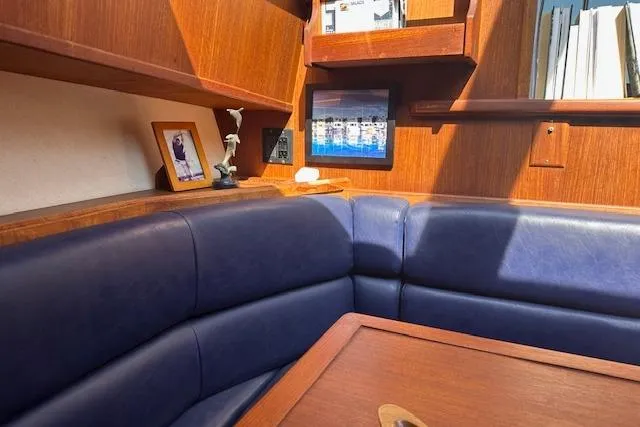 Arete Yacht Photos Pics 1988 Viking 45 Convertible yacht interior with blue leather seating and wooden accents.
