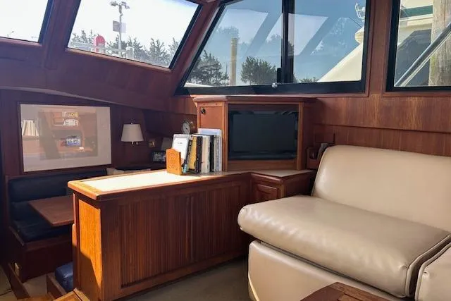 Arete Yacht Photos Pics Interior of 1988 Viking 45 Convertible yacht with wood paneling and leather seating.
