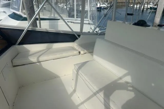 Arete Yacht Photos Pics 1988 Viking 45 Convertible boat interior with white seating and marina view.